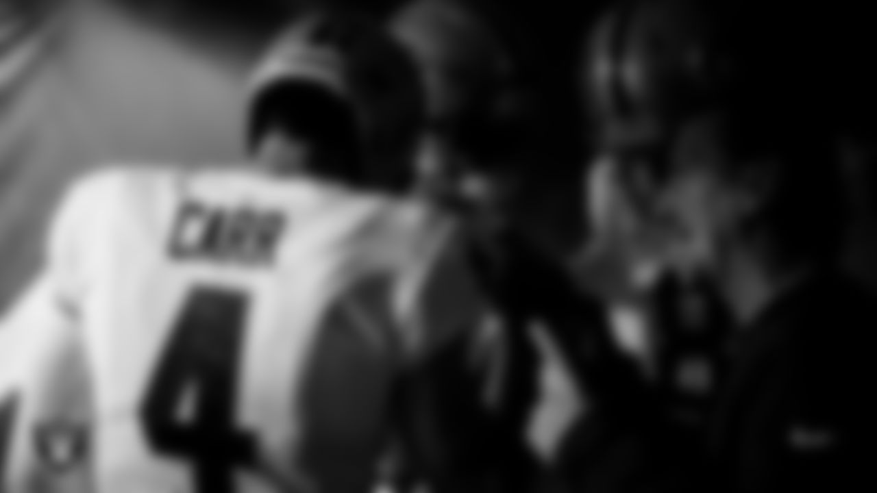 Las Vegas Raiders offensive coordinator Greg Olson huddles with the quarterbacks in the tunnel before the preseason game against the Los Angeles Rams at SoFi Stadium.