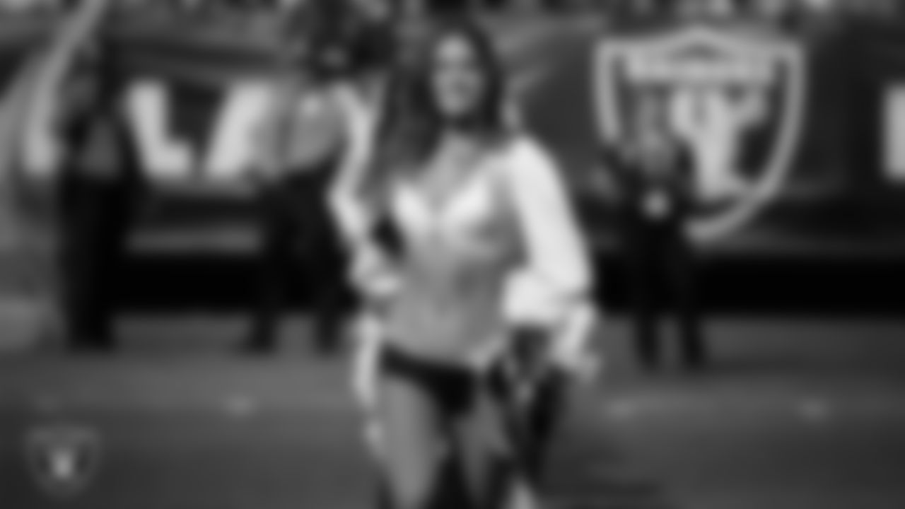 Raiderette Illora leads Junior Raiderttes onto the field before the Raiders preseason game against the Los Angeles Rams.