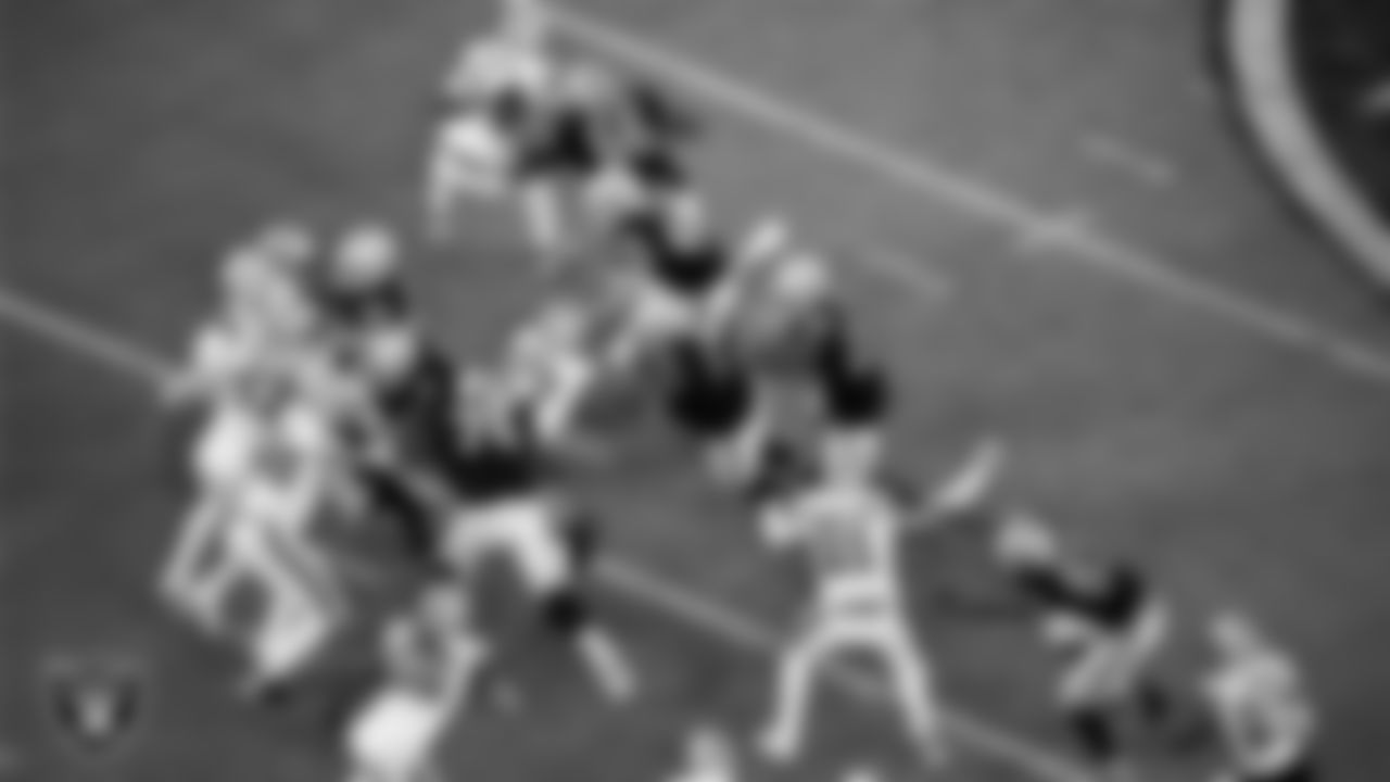 Las Vegas Raiders running back Josh Jacobs (28) rushes behind a block from center Rodney Hudson (61) during the regular season home game against the New Orleans Saints.