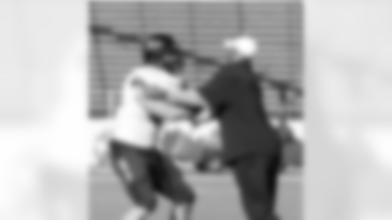 Offensive quality control Justin Griffith works with Colorado TE Nick Kasa.