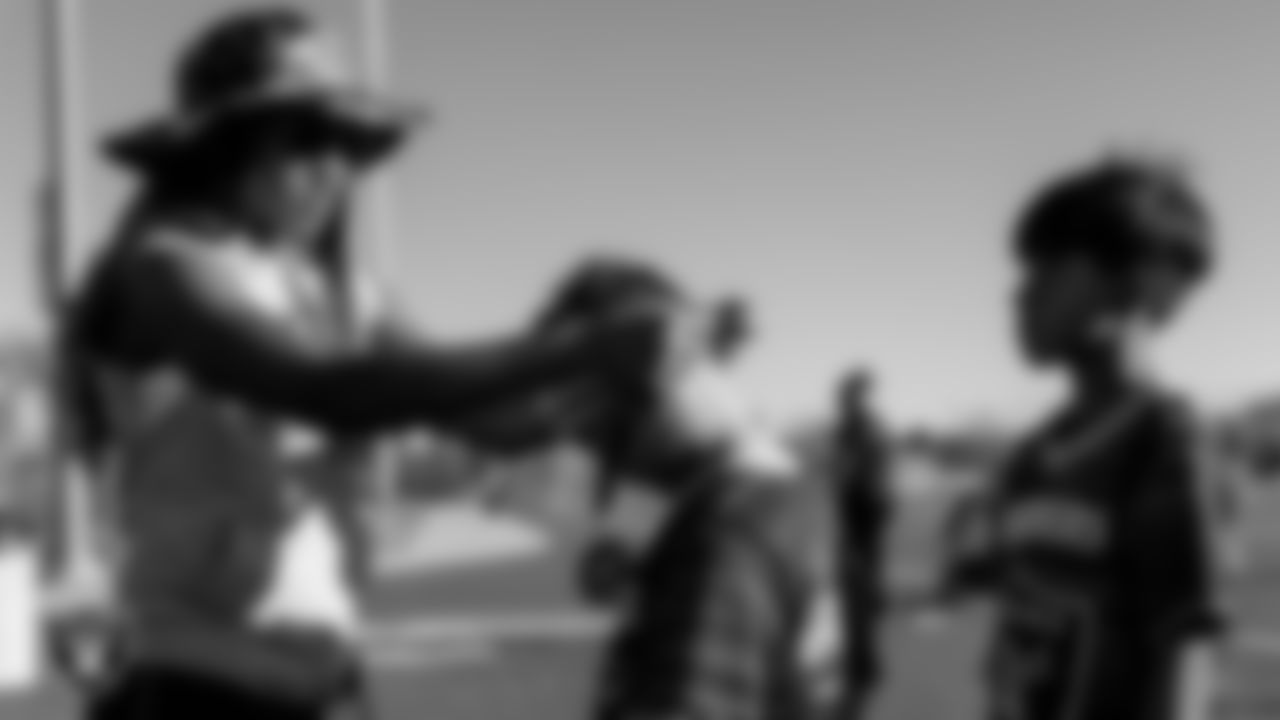 Las Vegas Raiders manager of football development Marli Bartlett presents a medal to an athlete before an end of the season Silver and Black Flag Football League championship game at Teton Trails Park.