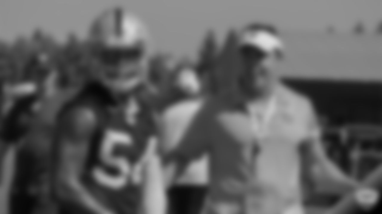 Oakland Raiders linebacker Brandon Marshall (54) and alumnus Bill Romanowski on the field for practice at 2019 Training Camp.