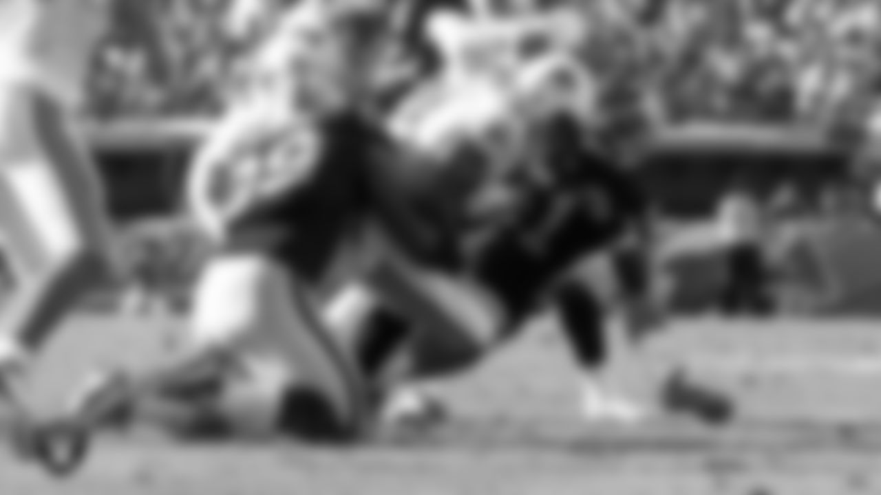 Raiders defensive end Lamarr Houston (99) makes a tackle during the regular season away game against the Miami Dolphins at Sun Life Stadium, Sunday, December 4, 2011, in Miami Gardens, Fla.