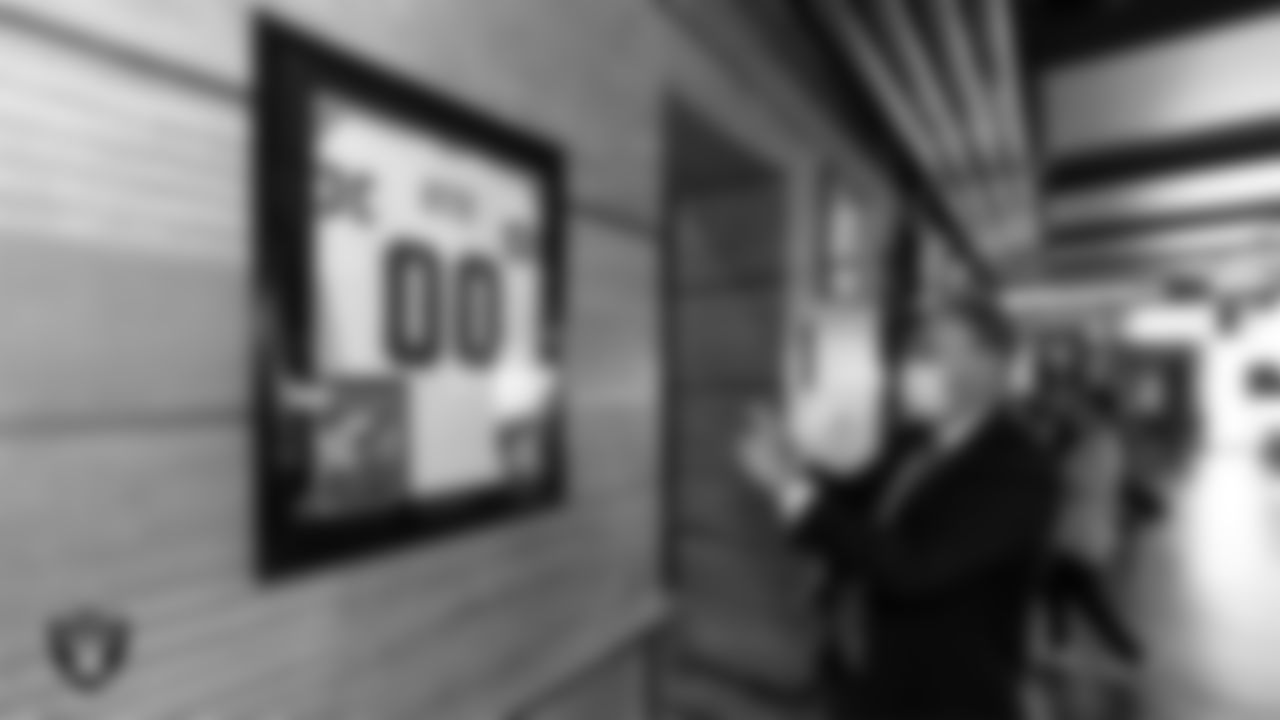 A member of the media takes a photo of a signed jersey of Las Vegas Raiders Hall of Famer Jim Otto during the opening of the Raiders Tavern & Grill at M Resort Spa Casino.