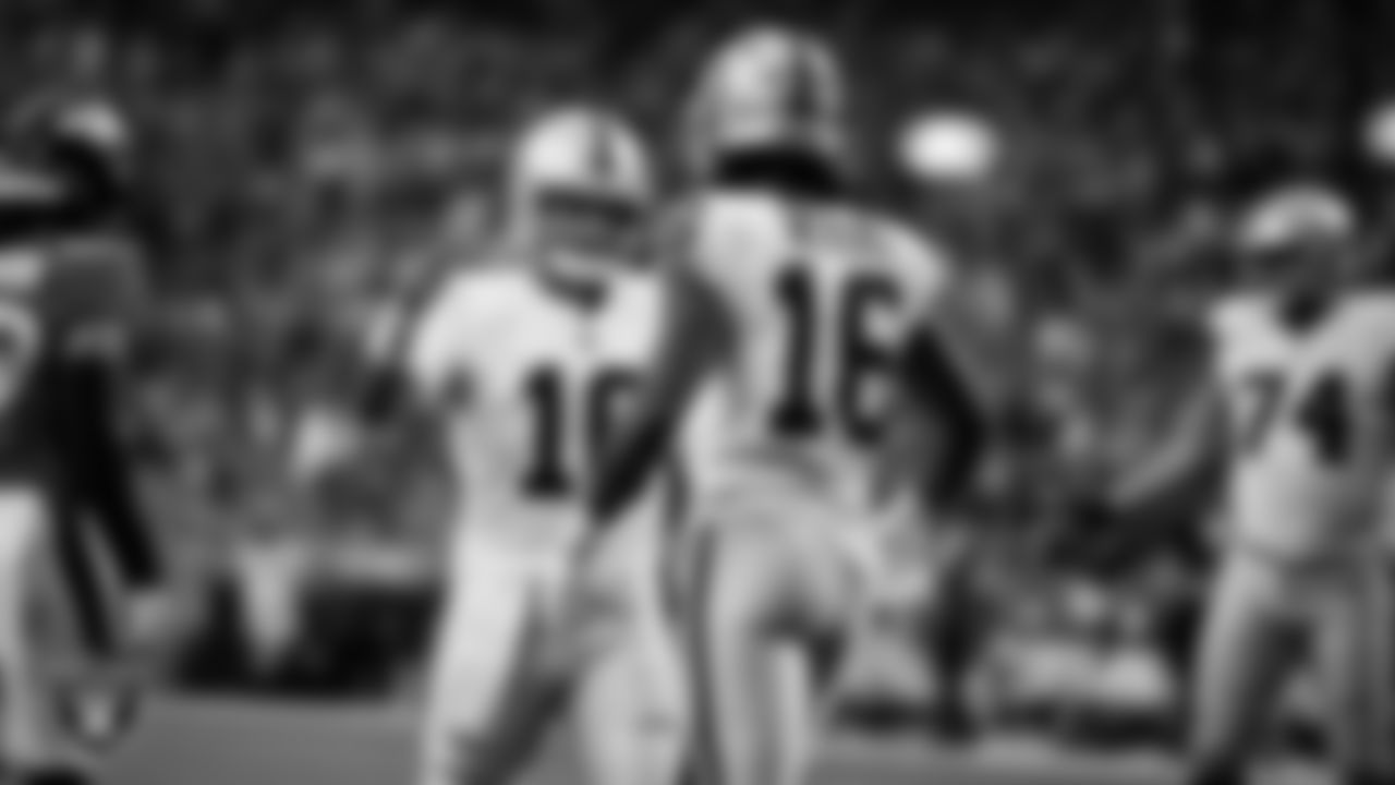 Las Vegas Raiders wide receiver Jakobi Meyers (16) celebrates with quarterback Jimmy Garoppolo (10) after making a 6-yard touchdown catch during the regular season away game against the Denver Broncos at Empower Field at Mile High.
