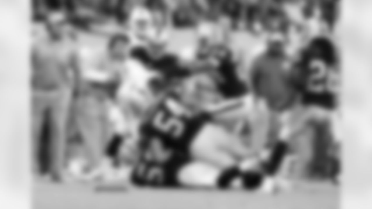 The Raiders defense team tackles the ball carrier.