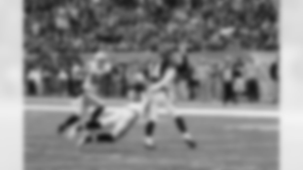 LB Philip Wheeler latches on to QB Andy Dalton as he tries to throw the pass.