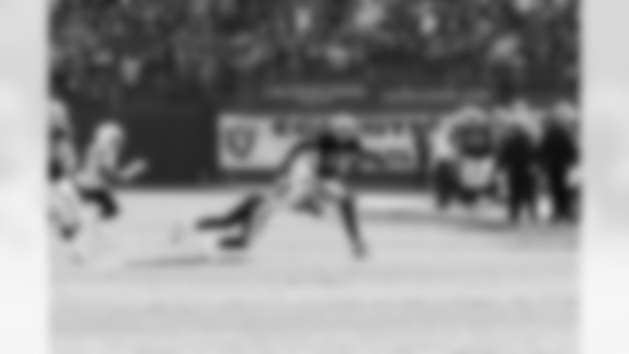 WR Louis Murphy tries to outrun the diving defender.