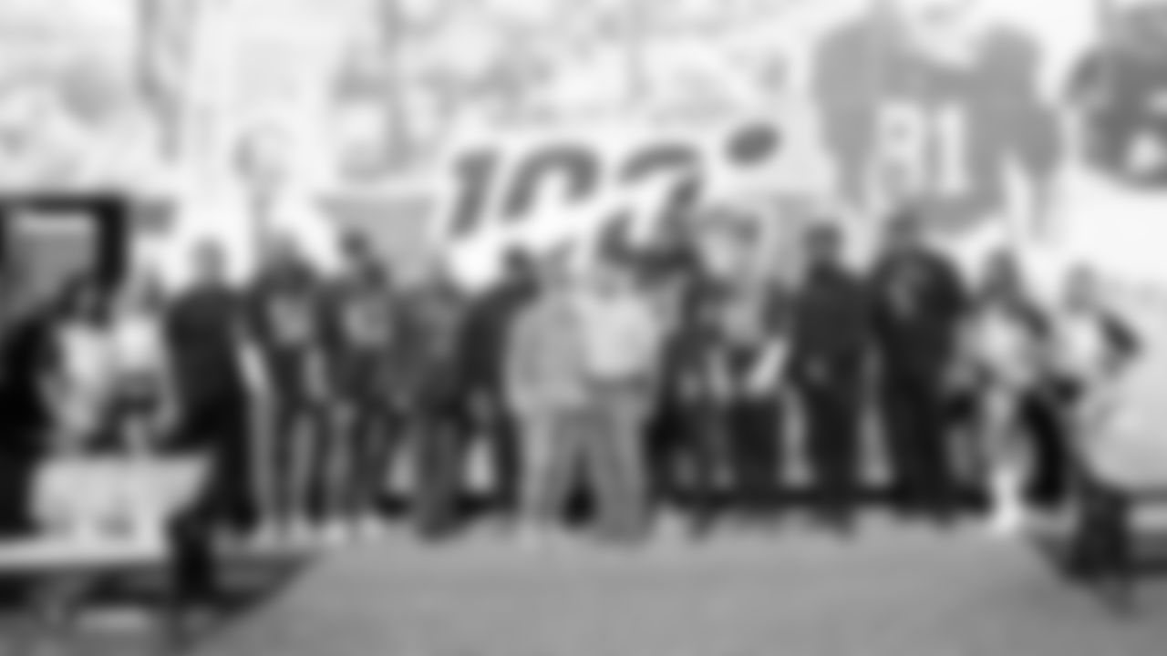 Raiderettes Shaniah, Summer, Illora, Rachel, alumni Jim Plunkett, Mark Van Eeghen, George Atkinson, Marcelle Reese, Lincoln Kennedy, linebacker Kyle Wilber (58), long snapper Trent Sieg (47), tight end Darren Waller (83) and fullback Alec Ingold (45) pose for a photo with U.S. servicemen and women stationed at Royal Air Force Mildenhall.