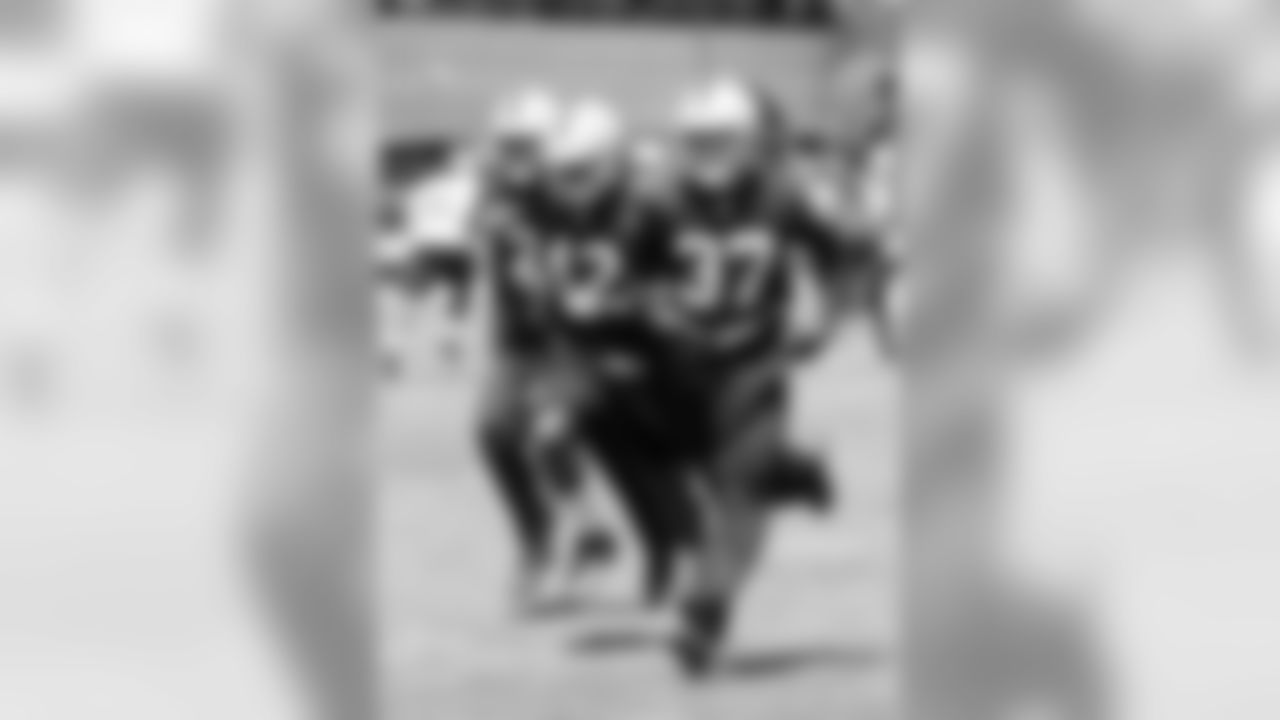 CB Mitchell White, S Shelton Johnson and DB Charles Woodson get moving.