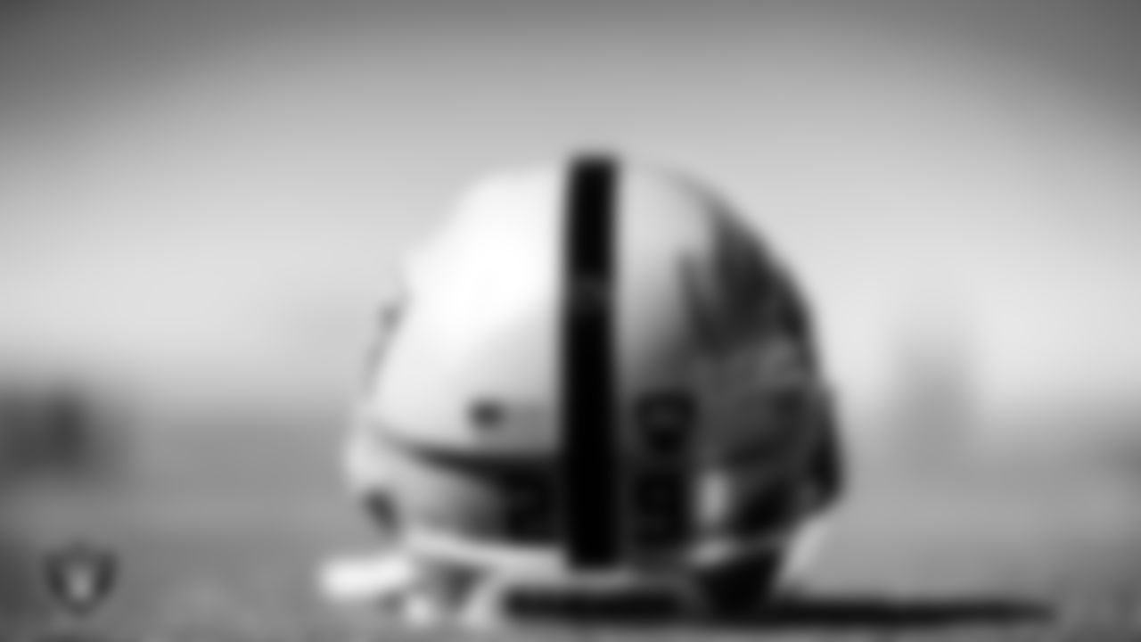 A Las Vegas Raiders helmet on the field for a walkthrough.