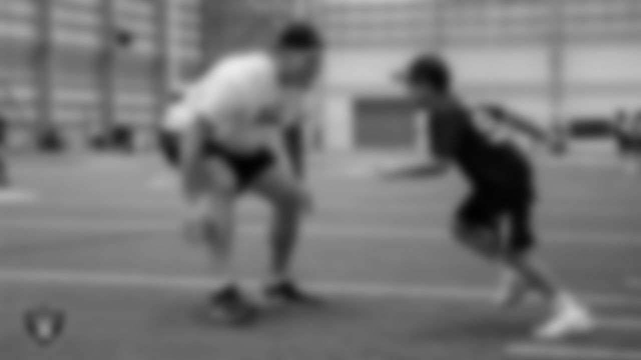 Las Vegas Raiders defensive end George Tarlas (79) works with an athlete on a drill during the Raiders Play Football Skills Camp at Intermountain Health Performance Center.