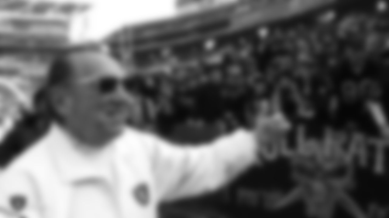 In this Dec. 26, 1998 file photo, Oakland Raiders owner Al Davis gives a thumbs-up to fans prior to the game with the Kansas City Chiefs, in Oakland, Calif. (AP Photo/Paul Sakuma)
