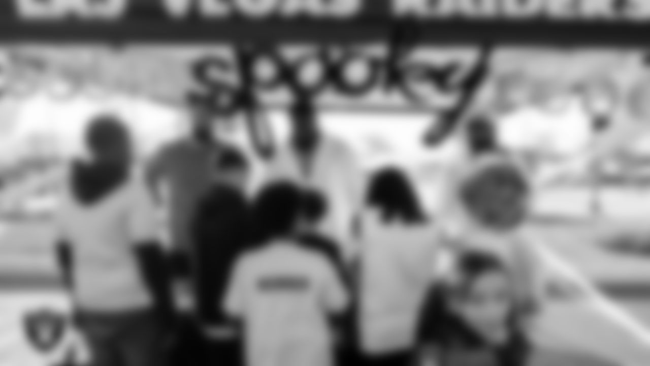 Las Vegas Raiders tight end Cole Fotheringham (85), defensive tackle Matthew Butler (94) and safety Matthias Farley (41) hand out candy and Raiders gear to members of the Boys and Girls Clubs of Southern Nevada.