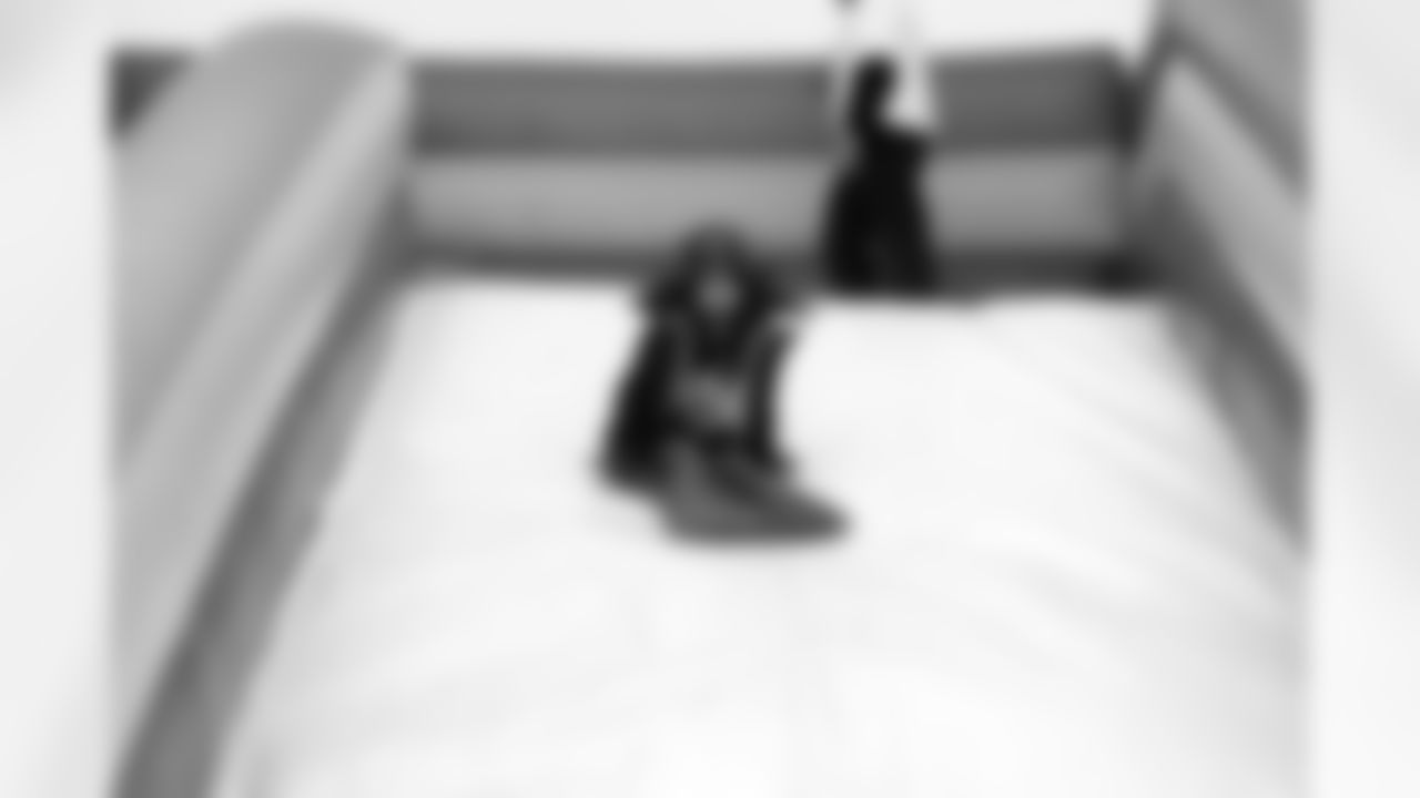 A young fan goes down the slide at the Raiders Family Zone.