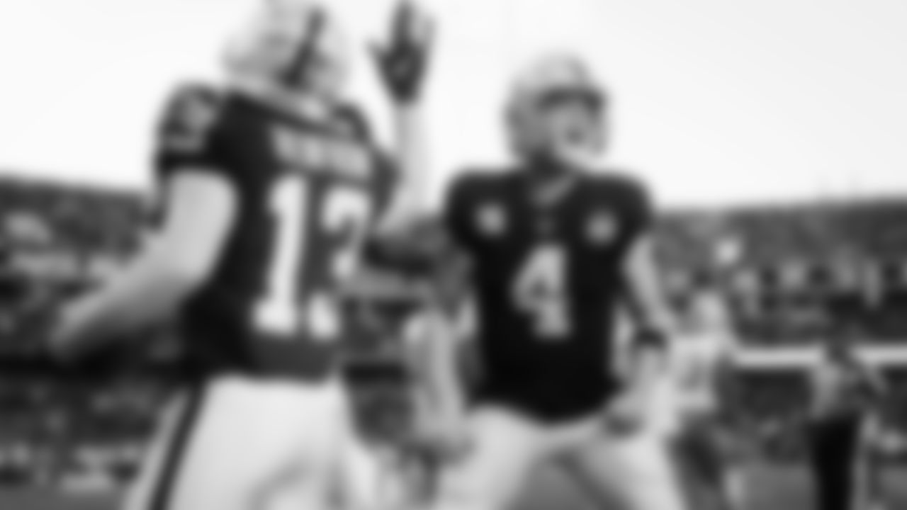 Raiders quarterback Derek Carr (4) celebrates a 9-yard touchdown pass to wide receiver Hunter Renfrow (13) during the regular season game against the Detroit Lions.