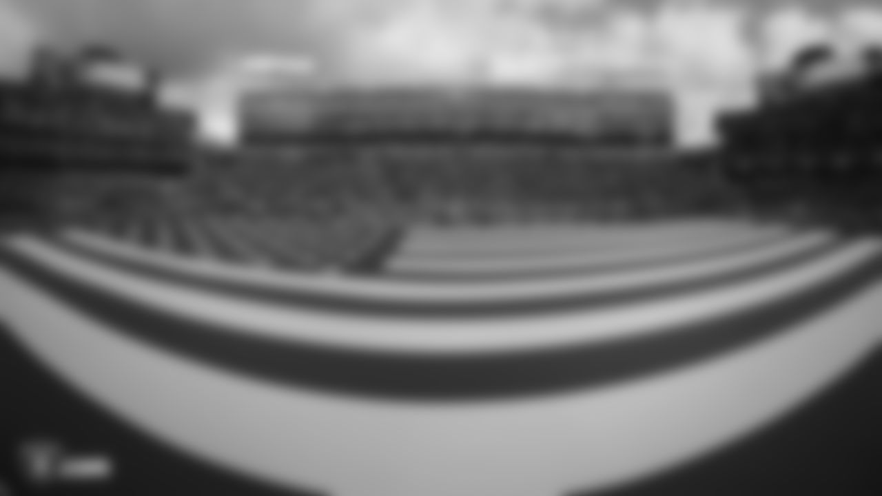The American flag is displayed by season ticket members on the field during the national anthem before the Raiders regular season game against the Tennessee Titans.