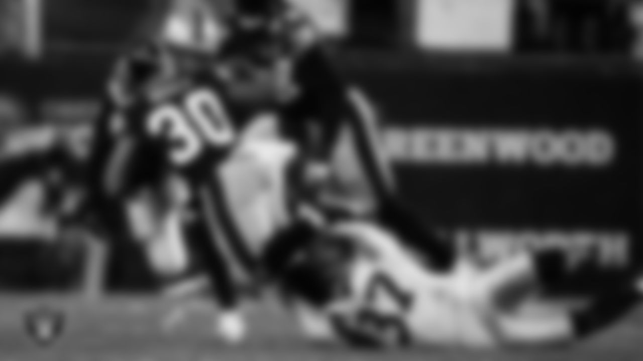Las Vegas Raiders cornerback Tyler Hall (37) and safety Tre'von Moehrig (25) make a tackle during the regular season away game against the Pittsburgh Steelers at Acrisure Stadium.