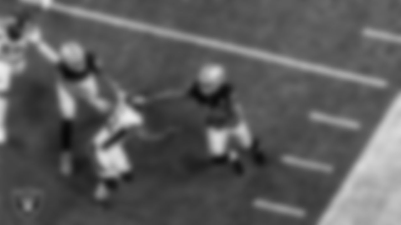 Las Vegas Raiders running back Josh Jacobs (28) stiff arms the defender during the regular season home game against the Denver Broncos.