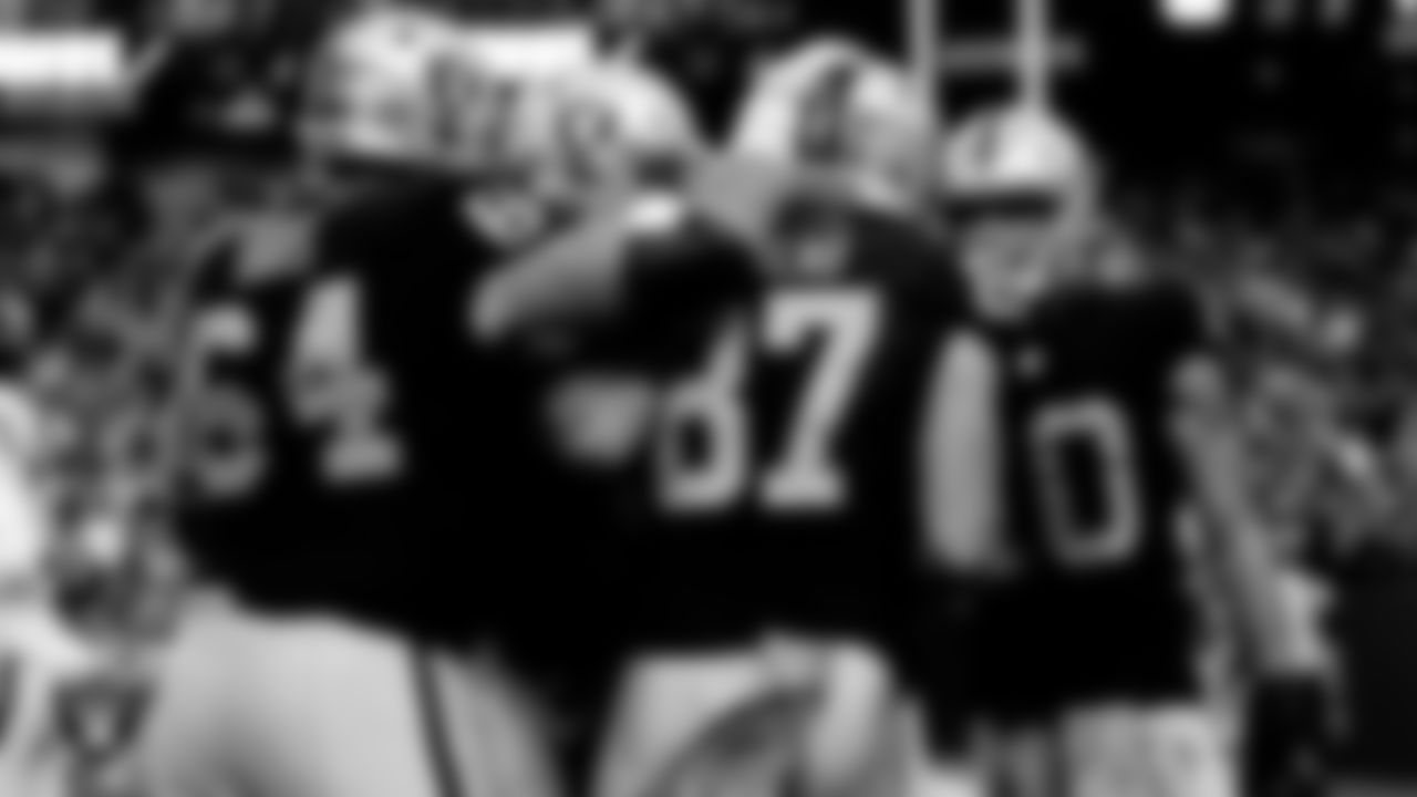 Las Vegas Raiders tight end Foster Moreau (87) is congratulated by guard Alex Bars (64) and wide receiver Mack Hollins (10) after making a 4-yard touchdown catch during the regular season home game against the Indianapolis Colts at Allegiant Stadium.