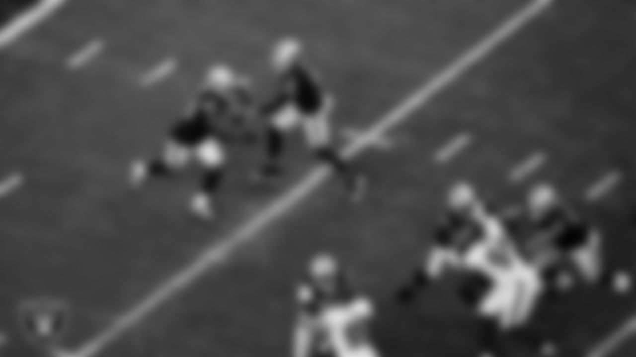 Las Vegas Raiders quarterback Derek Carr (4) hands the ball off to running back Josh Jacobs (28) during the regular season home game against the Washington Football Team.