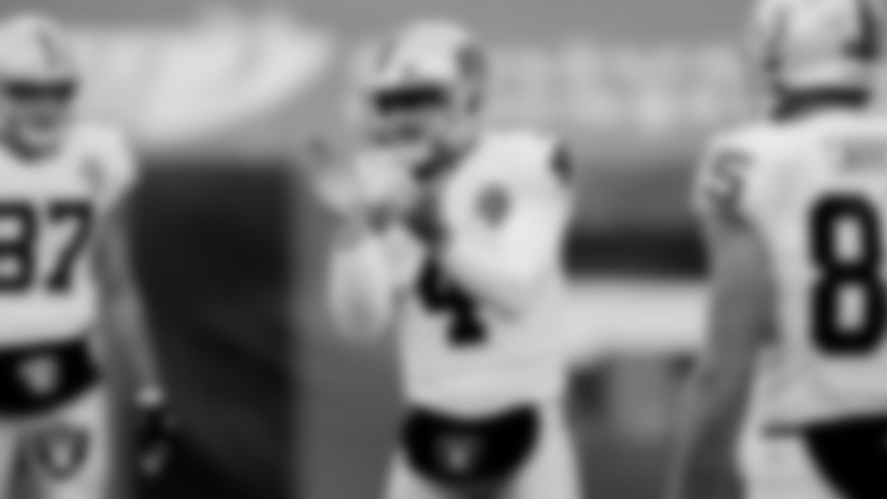 The Raiders warm up before the regular season game against the Cleveland Browns at FirstEnergy Stadium.