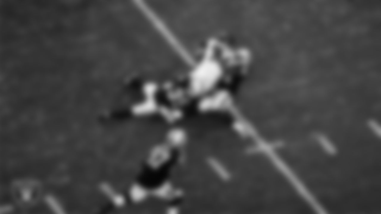 Las Vegas Raiders cornerback Nate Hobbs (39) and linebacker Cory Littleton (42) make a tackle during the regular season home game against the Washington Football Team.