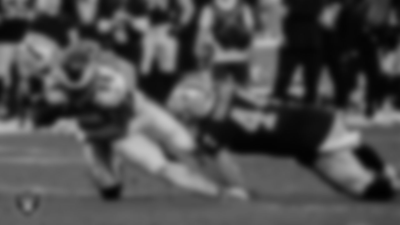Las Vegas Raiders safety Dallin Leavitt (32) and linebacker Nick Kwiatkoski (44) make a tackle during the regular season home game against the Philadelphia Eagles.