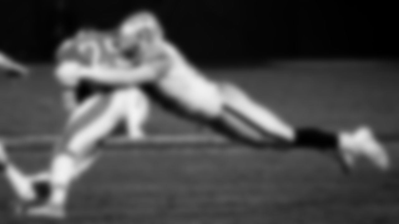 Raiders defensive end Maxx Crosby (98) makes a tackle during the regular season game against the Los Angeles Chargers.
