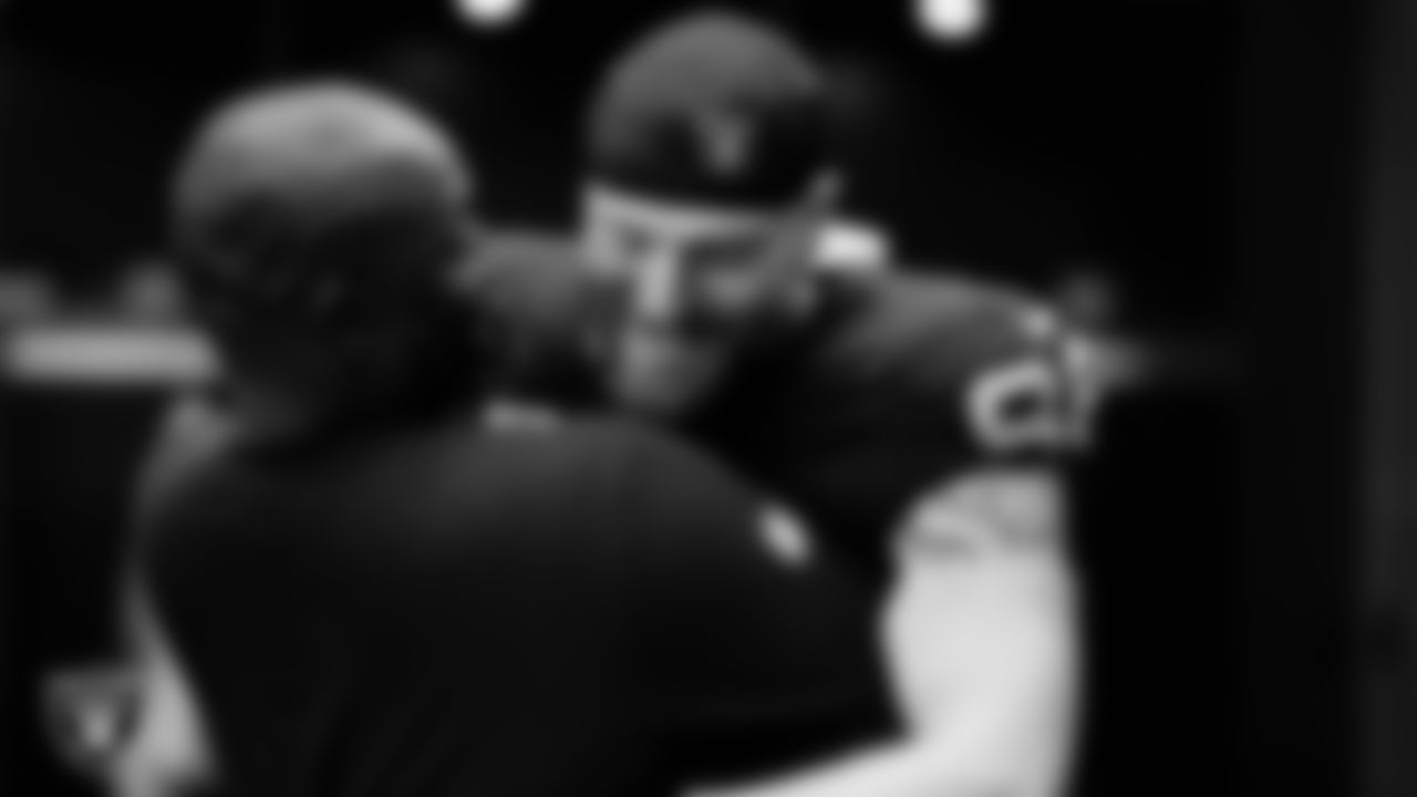 Las Vegas Raiders defensive coordinator Patrick Graham and defensive end Maxx Crosby (98) in the locker room after the regular season home game against the New England Patriots at Allegiant Stadium.