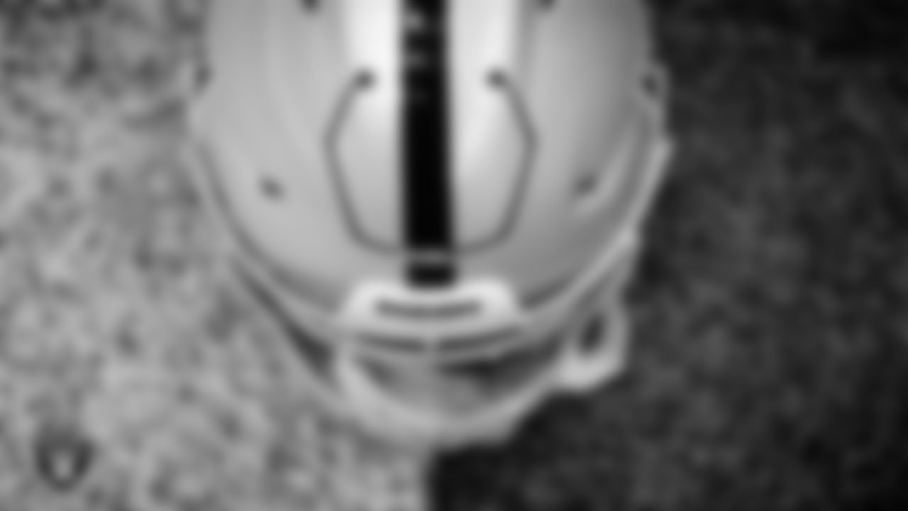 A Las Vegas Raiders helmet on the field for a walkthrough.