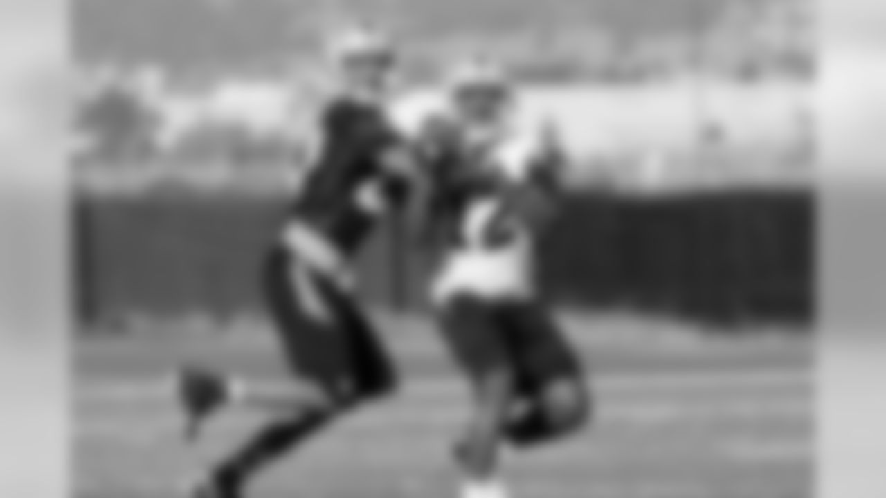 Rookies Jacoby Ford (12) fights for the ball with rookie CB Walter McFadden. Ford made the catch.