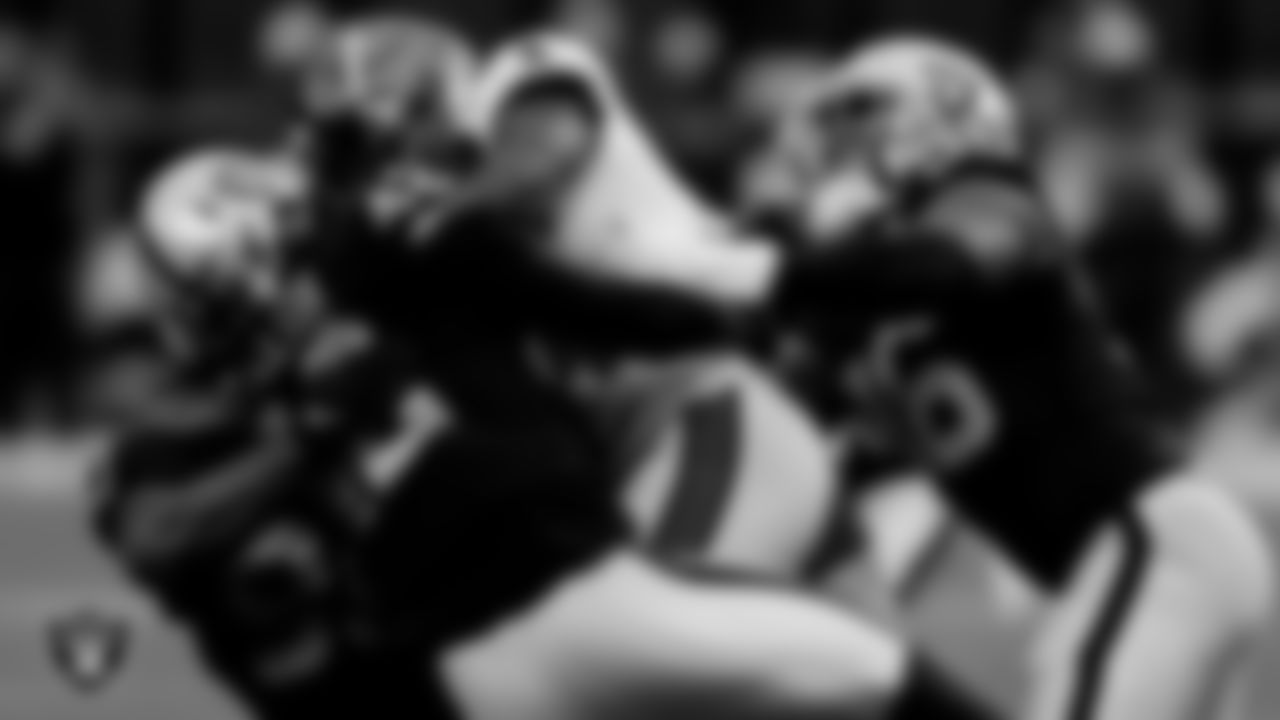 Las Vegas Raiders defensive tackle Johnathan Hankins (90), linebacker Cory Littleton (42) and defensive end Clelin Ferrell (96) during the regular season game against the Tampa Bay Buccaneers at Allegiant Stadium.