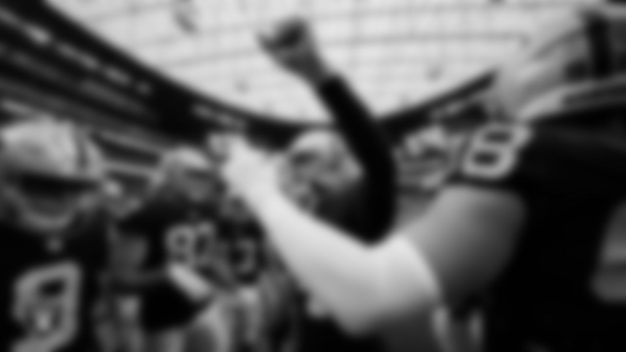 Las Vegas Raiders quarterback Derek Carr (4) fires the team up in a huddle during warm ups before the preseason home game against the Minnesota Vikings at Allegiant Stadium.