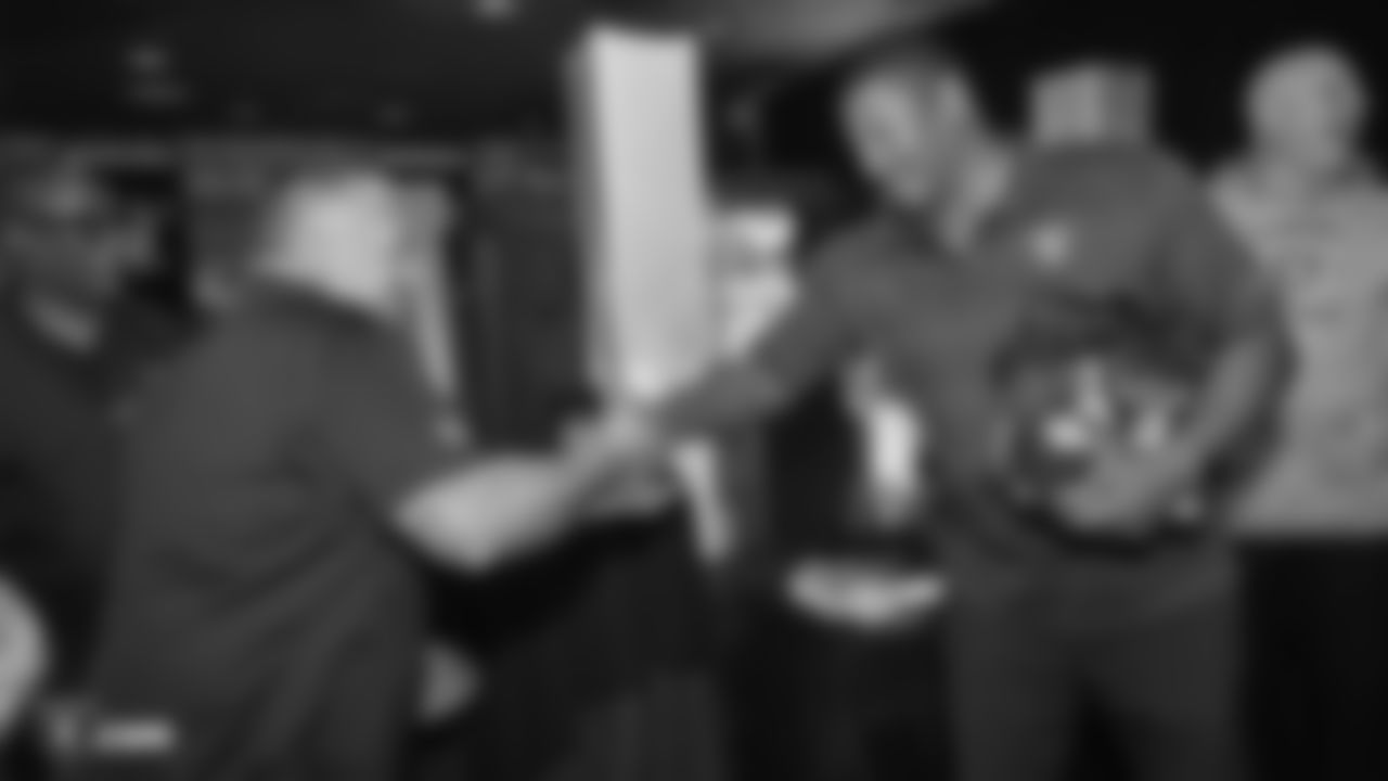 Raiders alumnus Napoleon McCallum congratulates an attendee after winning a raffle prize at a Watch Party for members of the Las Vegas Raiders Family Association, troops from Nellis Air Force Base and their families during the Raiders regular season game against the New York Jets.