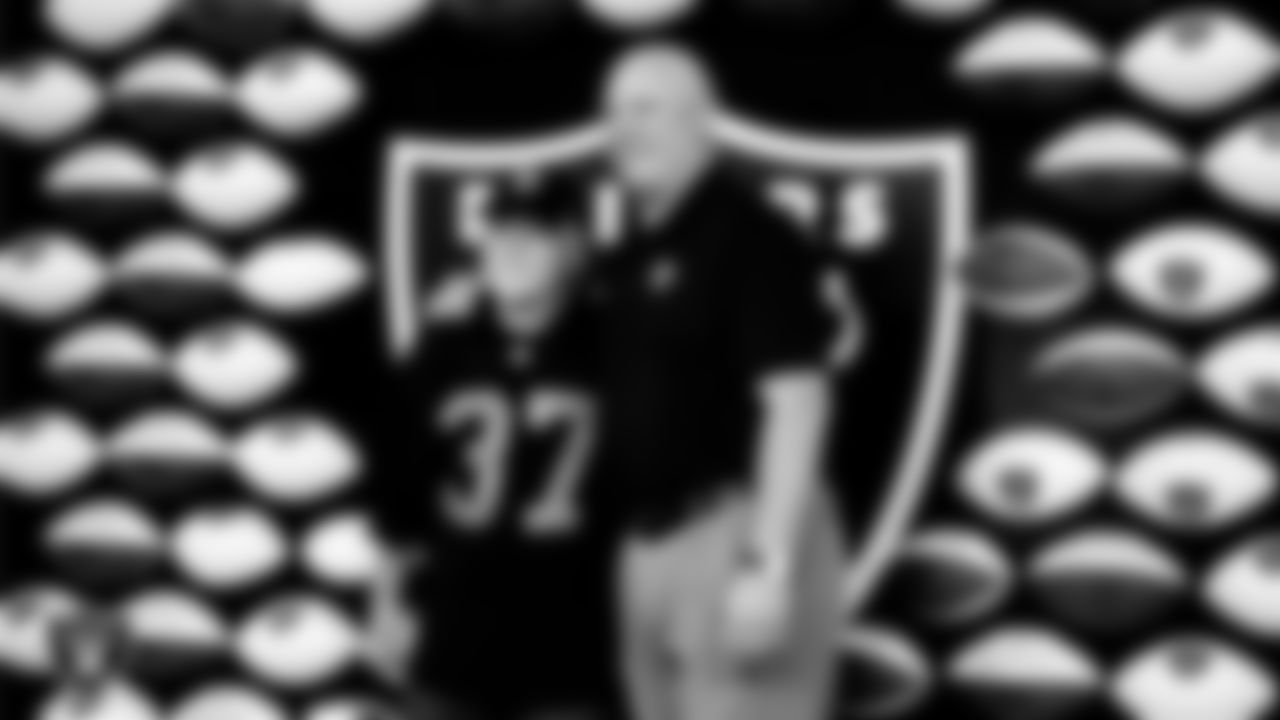 Las Vegas Raiders alumnus Jay Schroeder poses for a photo with a Season Ticket Holder during the appreciation event.
