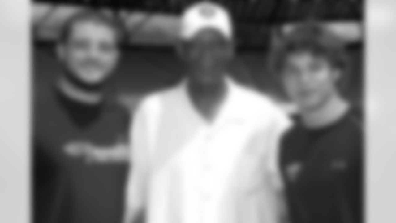 SWARCO Raiders players Markus Krause and Florian Hueter (left) pose for a photo with Hall of Famer Willie Brown.