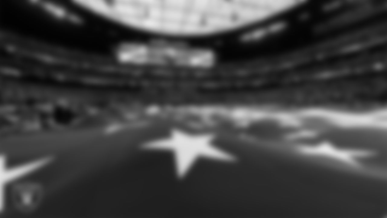The American flag is displayed by Personal Seat License (PSL) holders on the field during the national anthem before the Las Vegas Raiders' regular season home game against the New England Patriots at Allegiant Stadium.