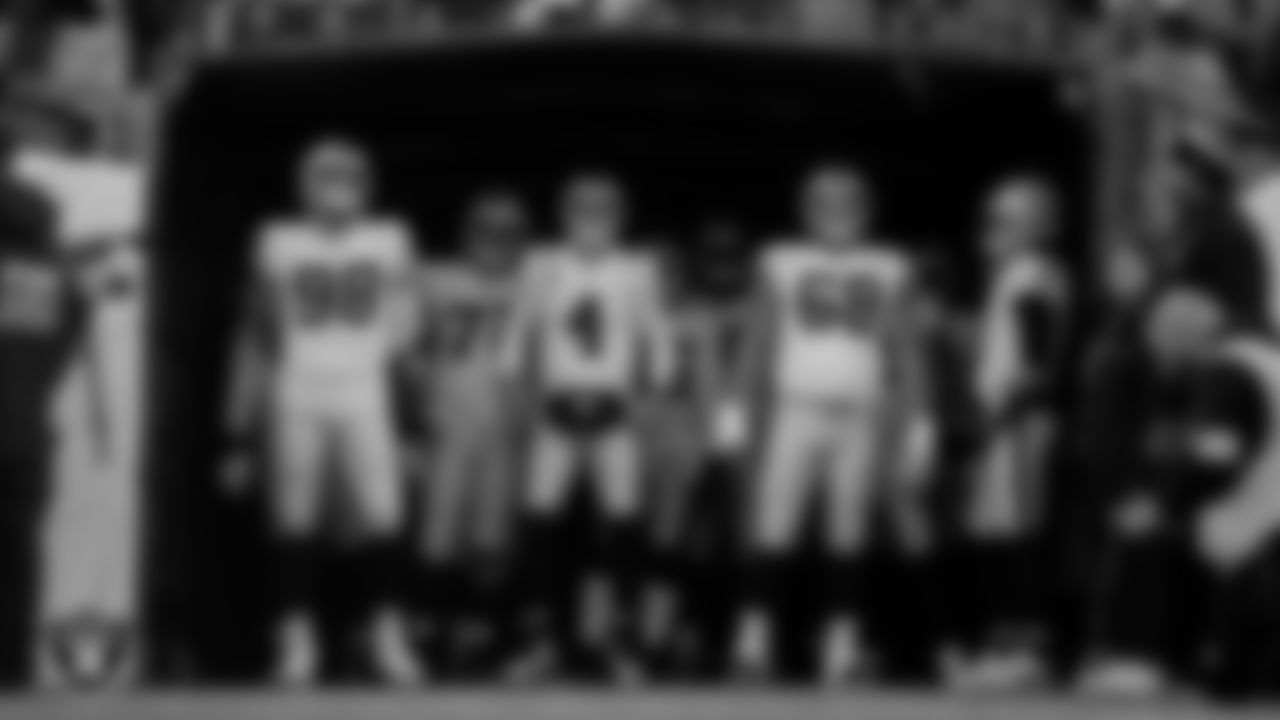 The Las Vegas Raiders wait to be introduced onto the field before the regular season away game against the Denver Broncos at Empower Field at Mile High.