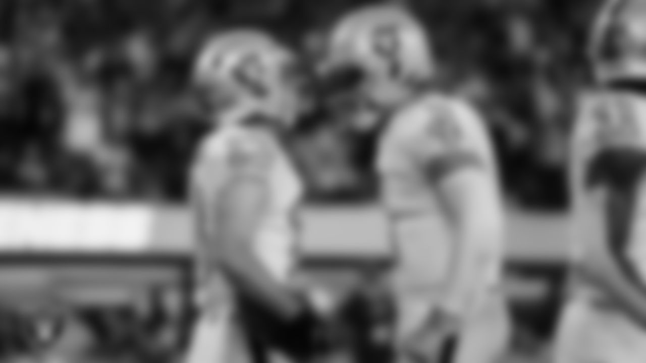 Las Vegas Raiders wide receiver Hunter Renfrow (13) and quarterback Derek Carr (4) celebrate after connecting for a 10-yard touchdown during the regular season away game against the Los Angeles Chargers.