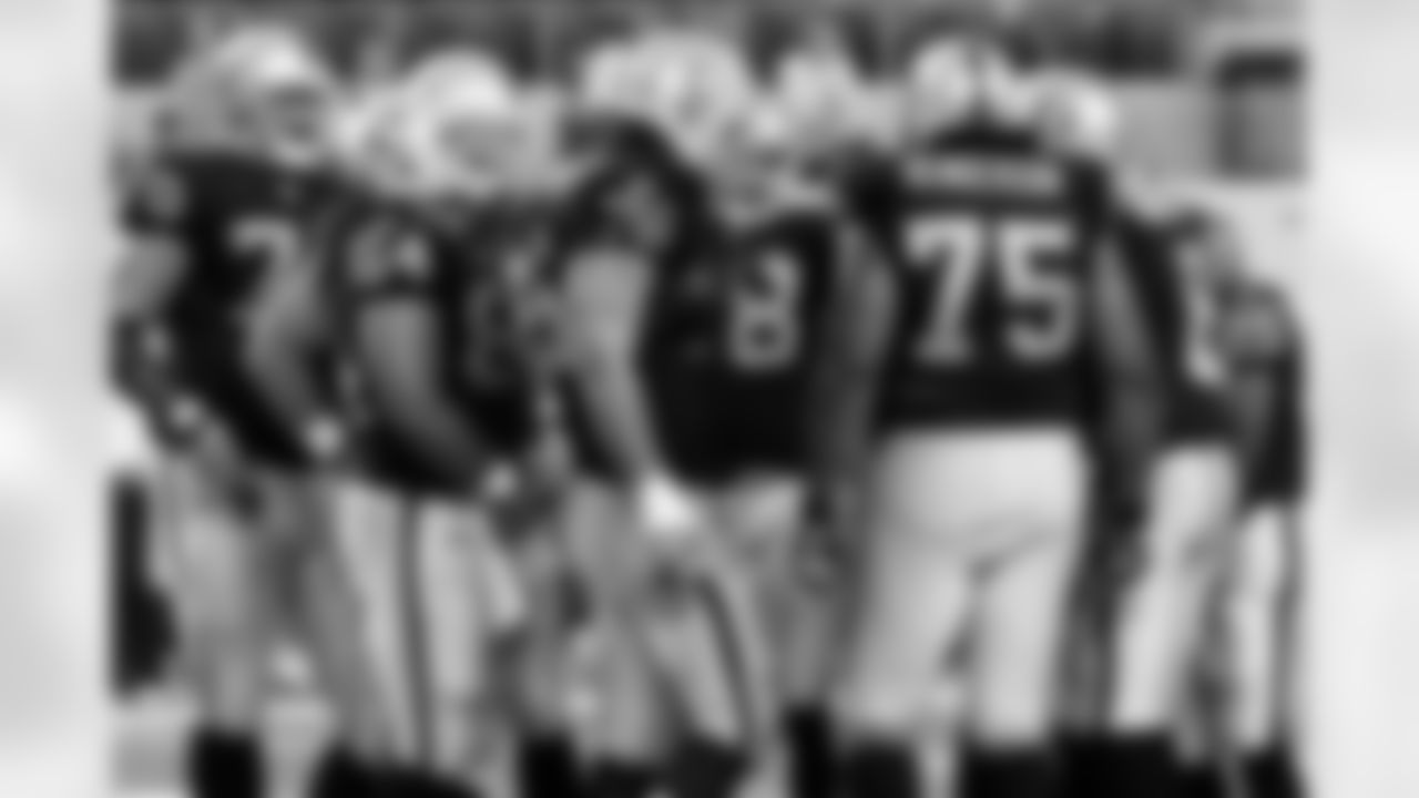 The Raiders offense huddles up. Photo by Tony Gonzales.