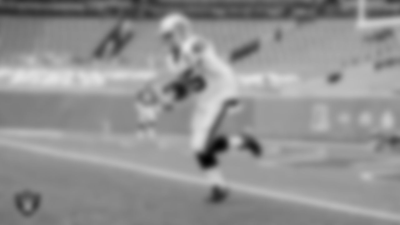 The Raiders warm up before the regular season game against the Denver Broncos at Empower Field at Mile High.