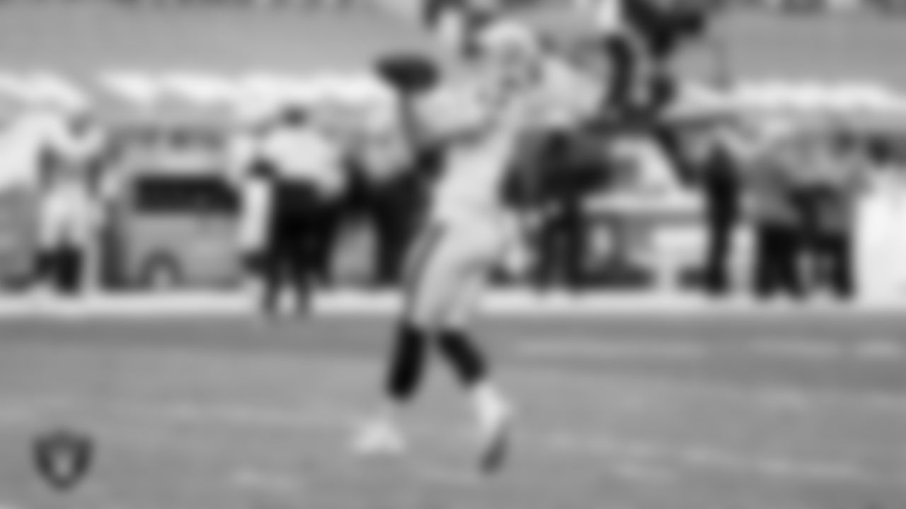 The Raiders warm up before the regular season game against the Denver Broncos at Empower Field at Mile High.