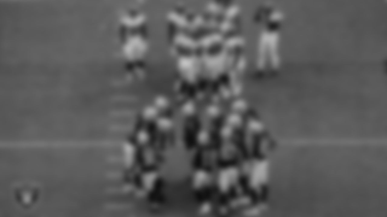 The Las Vegas Raiders huddle during the regular season game against the Tampa Bay Buccaneers at Allegiant Stadium.