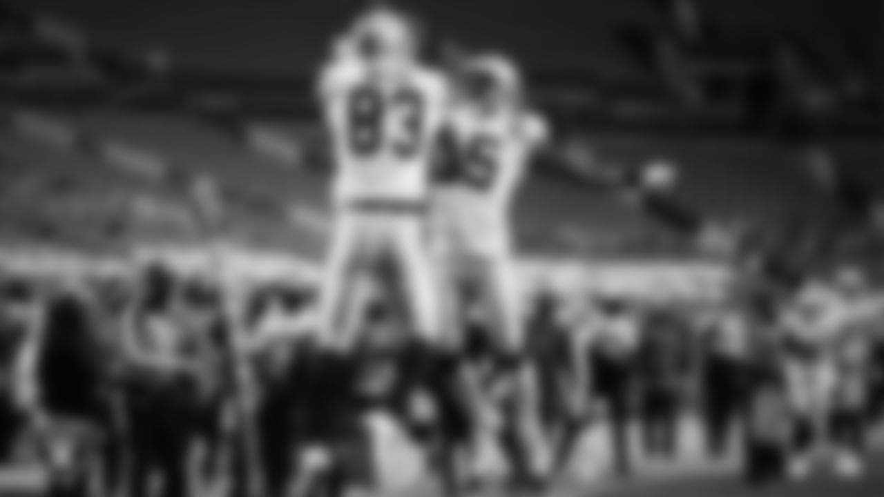 Las Vegas Raiders tight end Darren Waller (83) celebrates with wide receiver Nelson Agholor (15) after making a 28-yard touchdown catch during the regular season away game against the Denver Broncos.