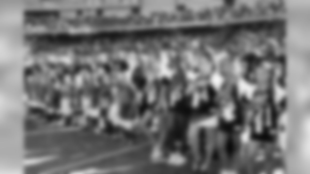 Dublin Falcons youth football and cheer stand with the team during the national anthem.