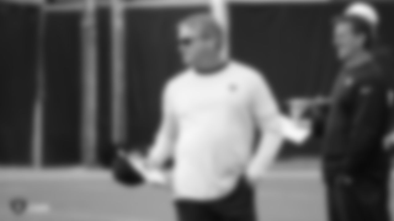 Raiders Head Coach Jon Gruden stands on the field during practice.