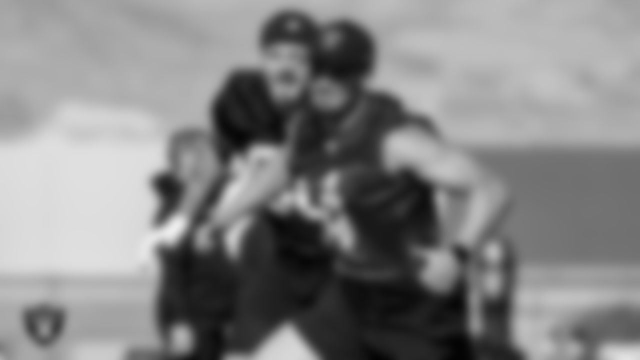 Las Vegas Raiders defensive end Maxx Crosby (98) and quarterback Derek Carr (4) at a workout during phase two of the offseason program.