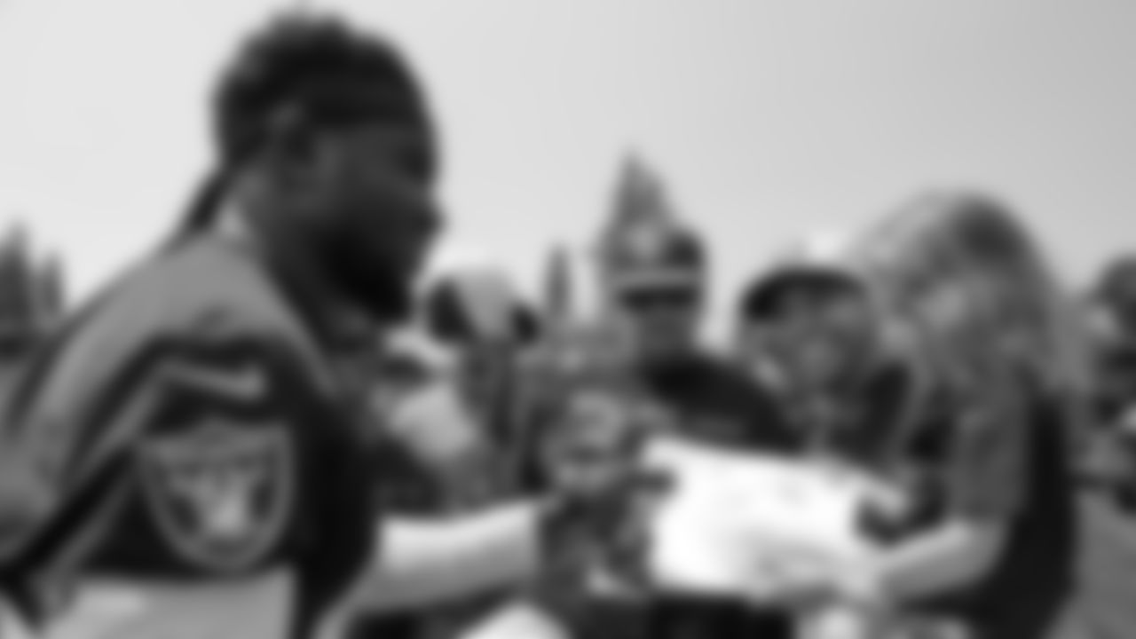 Oakland Raiders strong safety Karl Joseph (42) signs autographs for fans after practice at 2018 Training Camp at The Oakland Raiders Napa Valley Training Complex, Wednesday, August 1, 2018, in Napa, California.