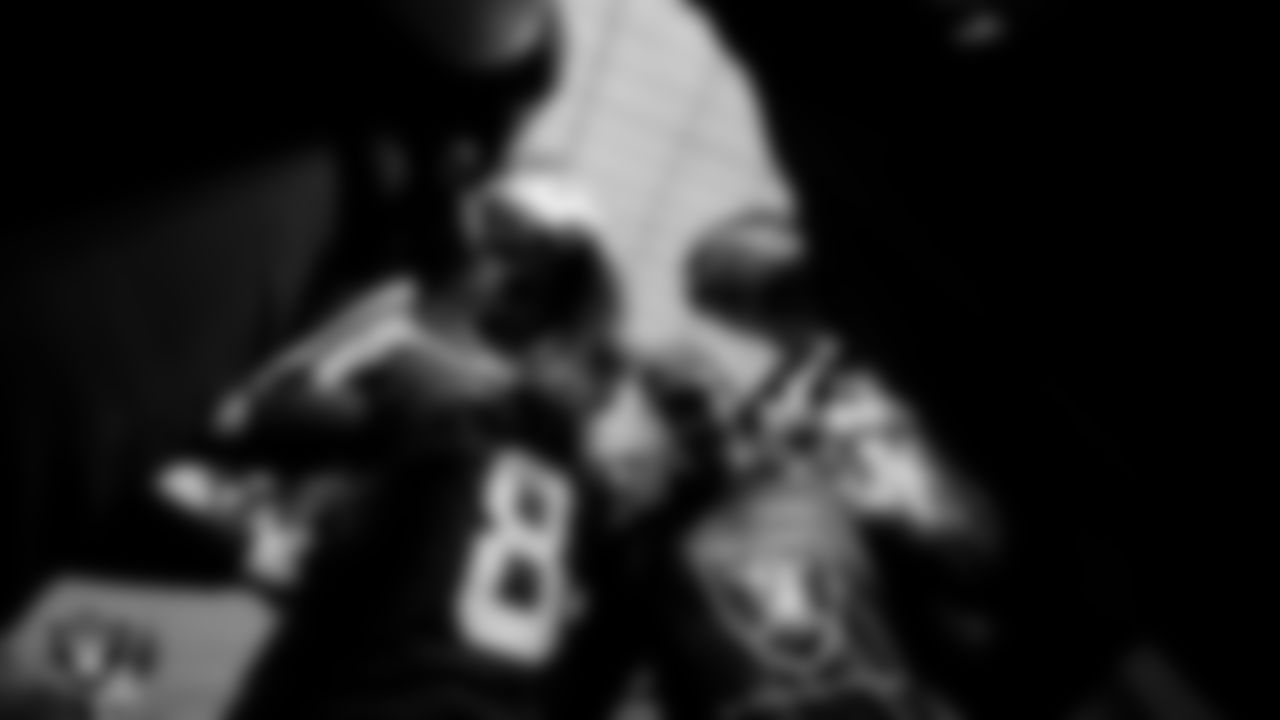 The Las Vegas Raiders quarterbacks huddle in the tunnel before the regular season home game against the Los Angeles Chargers.